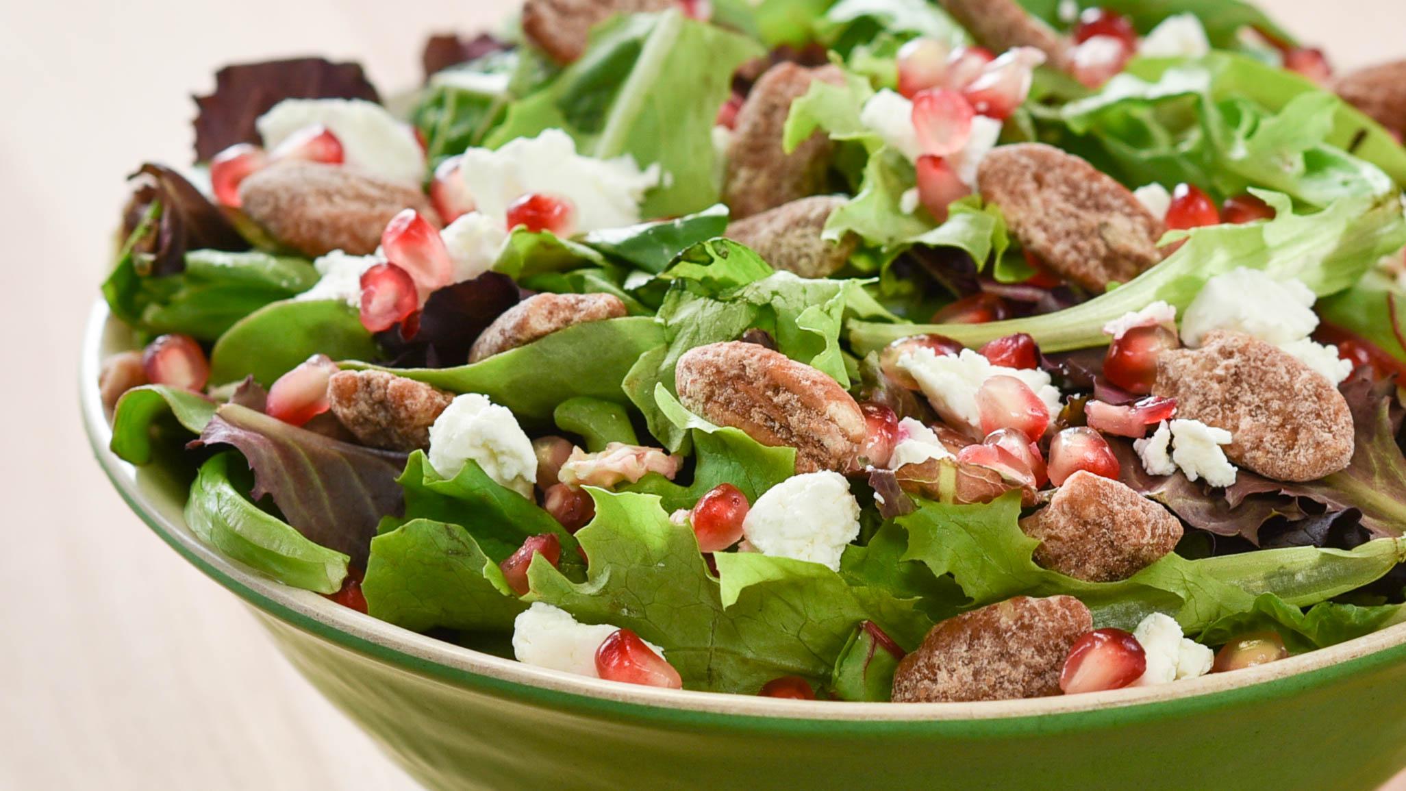 A bright salad of greens, pomegranate, goat cheese and candied nuts